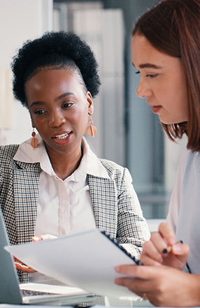 man taking notes near computer