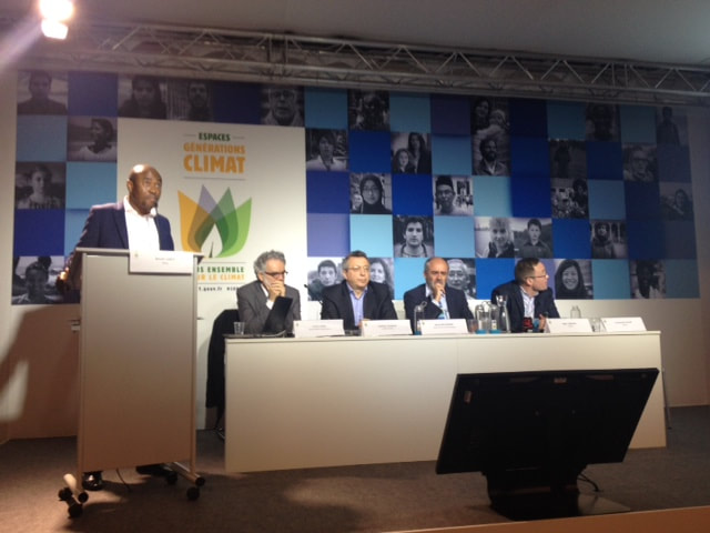 Dr. Ackom speaking in Paris