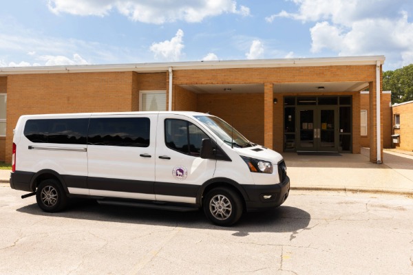 UNA shuttle van in front of doors at East Campus