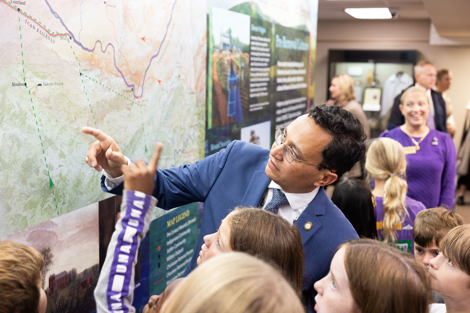 Cherokee Nation Principal Chief Chuck Hoskins Jr. interacts with the new mural honoring North Alabama's First People which was recently unveiled in Collier Library.