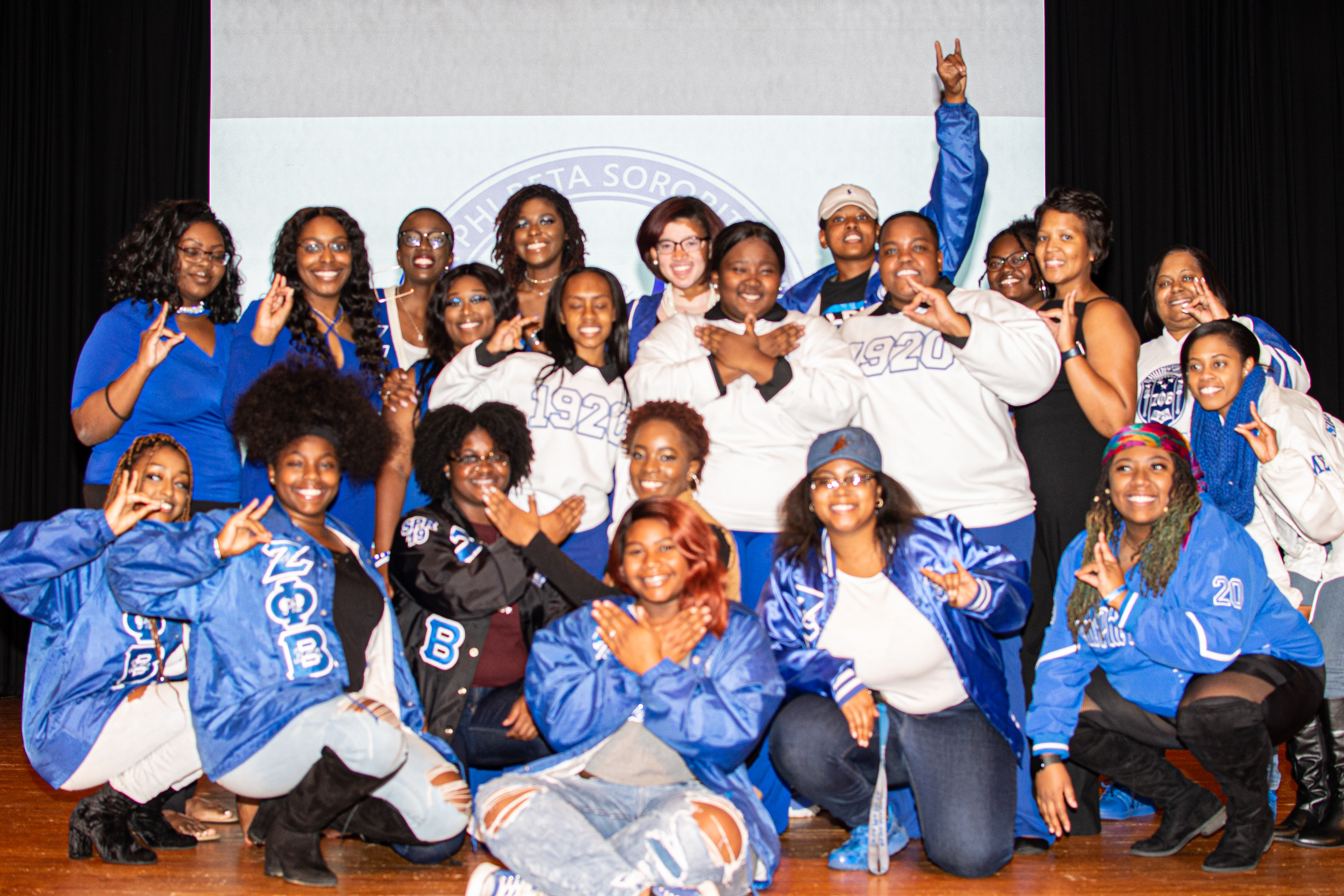 Members of Zeta Phi Beta Sorority, Inc. gather on stage for a group photo after their new member presentation.