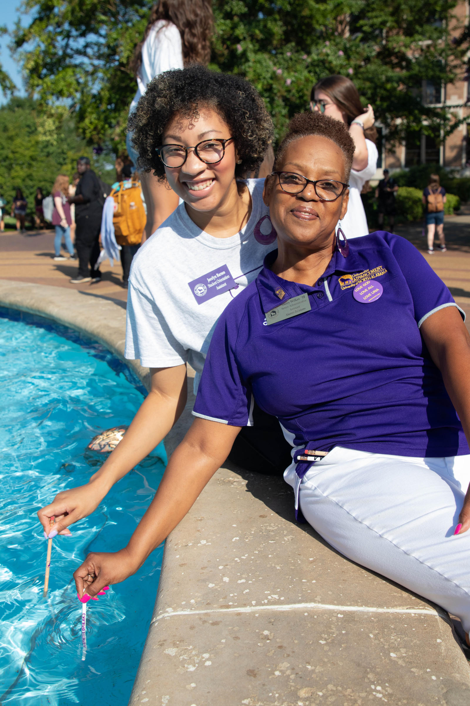 SOAR Counselor and Alumni Relations dipping their pencils in Harrison Fountain